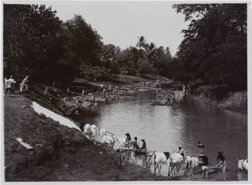 Activity on a River in Indonesia with Rafts and People Washing