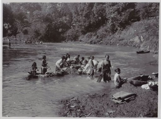 Women Washing Clothes on Rocks in the River