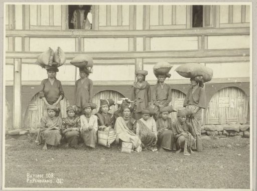 Group portrait of a group of unknown women with goods for sale on their way to the Pasar