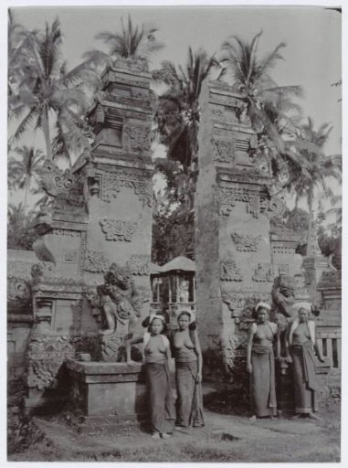 Four Young Ladies in Bare Upper Bodies Posing Before a Temple Gate in South Bali