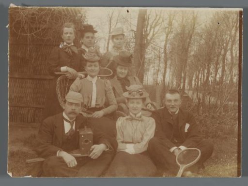 Portrait of a group of unknown people, one with a camera