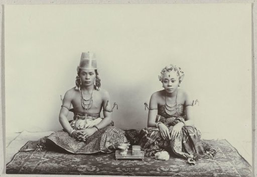 Studio Portrait of a Seated Young Javanese Man and Woman Wearing a Batik Sarong