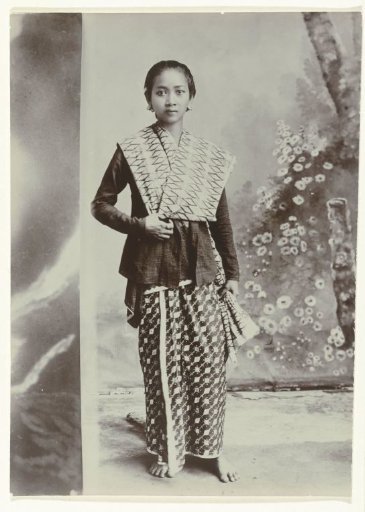 Studio Portrait of a Young Javanese Woman in a Sarong with a Batik Motif and a Checkered Shirt