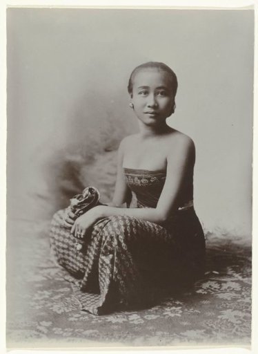 Studio Portrait of a Seated Young Javanese Woman in a Sarong with a Batik Motif