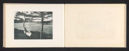 View of a bay with a boat on the shore in presumed Maine