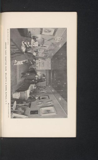 Reception of a building with unknown people and various portraits on the wall