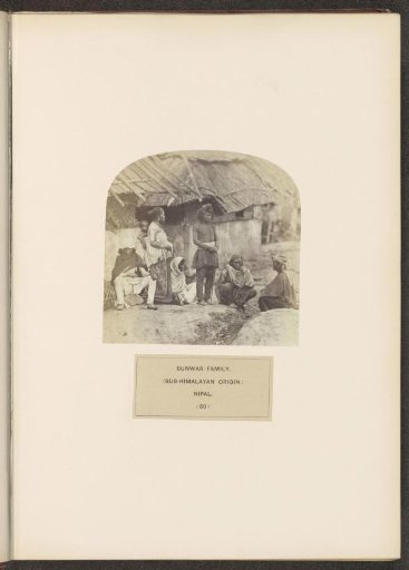 An unknown family on the street in front of houses from the Sunuwar tribe of Nepal