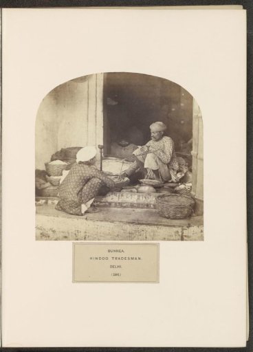 A Shopkeeper from the Bania Community with a Man in Front of His Wares in Delhi, India