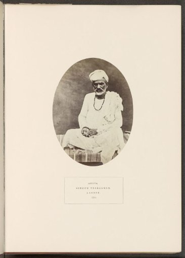 Portrait of an unknown tradesman from the Arora community of Lahore, Punjab, Pakistan, with coins in hand and in front of him
