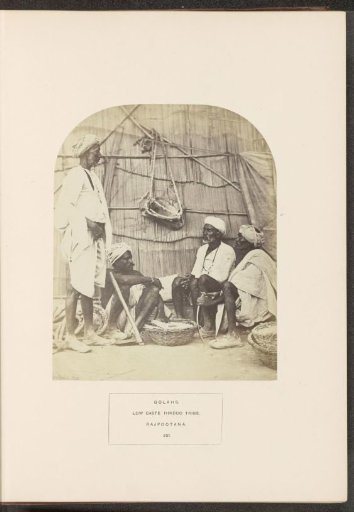 Four men from the Gola tribe around a basket with salt, India