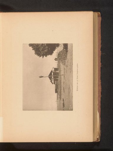 Dwelling with a pole and a pile of stones in front