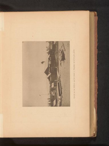 View of a dwelling on the beach at Ampenan from the pier, with an outrigger canoe on the beach
