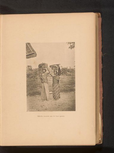 Two unknown women carrying baskets on their heads