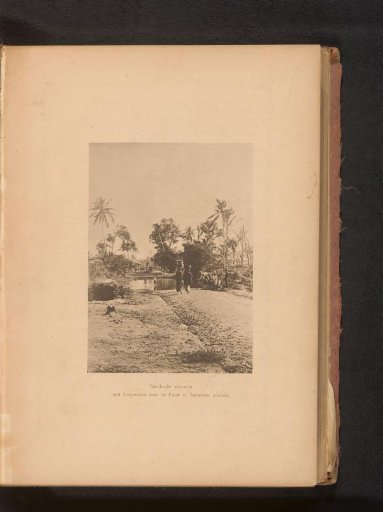 View of two unknown women with baskets on their heads on a path