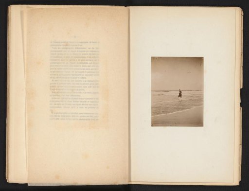 View of an unknown woman walking into the sea