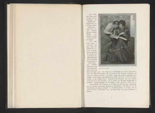 Two women leafing through a book
