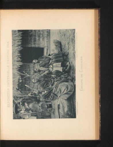 Four men sitting on a tree trunk in a reconstructed Congolese village at the World's Fair of Antwerp in 1894
