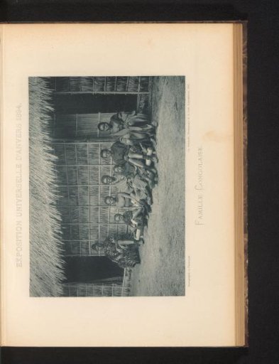 A family sitting in front of a house in a reconstructed Congolese village at the World's Fair of Antwerp in 1894