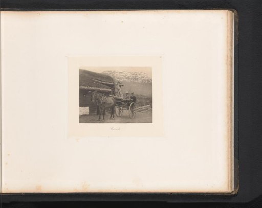 Two men in a carriage in the mountains