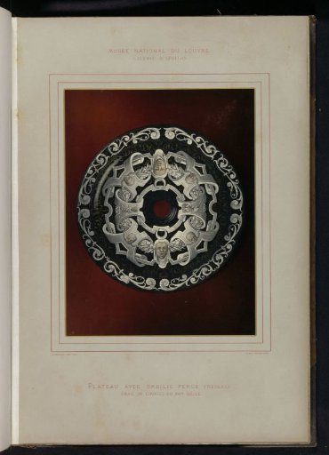 Round dish with a hole in the center, decorated by Pierre Raymond with heads and cherubs