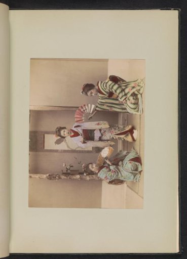 Three girls in kimonos with fans