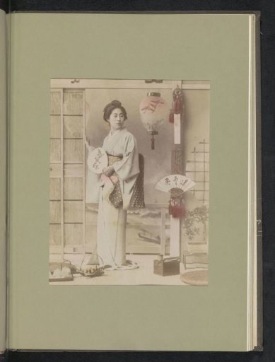 Portrait of a woman with a fan in an interior