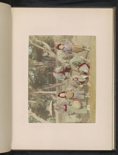 Child acrobats and their guide in a park