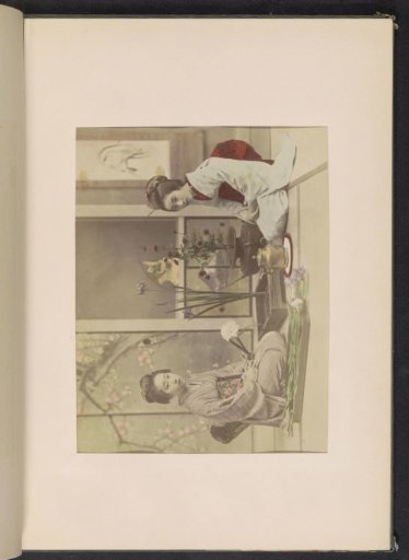 Two women arranging flowers in an interior