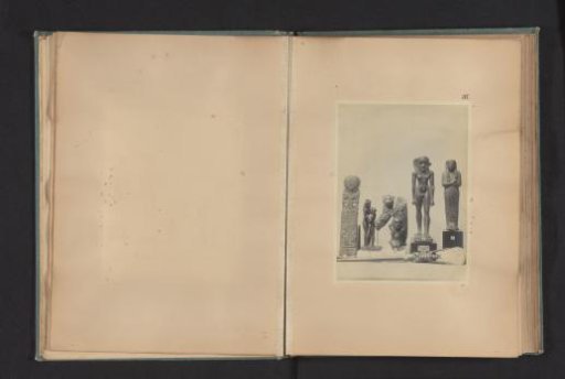 Seven Egyptian objects, including a bronze sculpture of Isis with Horus, a bronze sculpture of Harpocrates with the head of Bes, and a wooden ushabti
