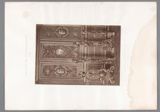 View of wooden paneling and four bronze and copper sculptures in the Galerie François Ier of the Château de Fontainebleau, France