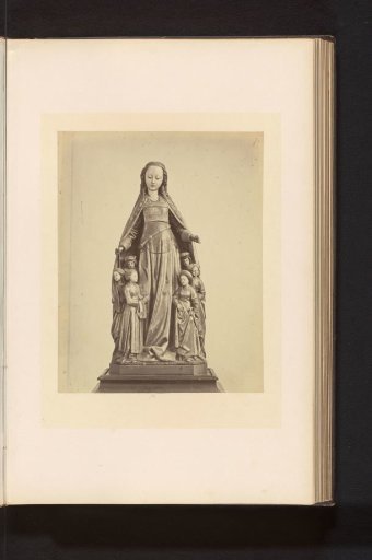 Colored oak sculpture of Mary hiding monks and nuns under her mantle, displayed at an exhibition of religious objects from the Middle Ages and the Renaissance in 1864 in Mechelen