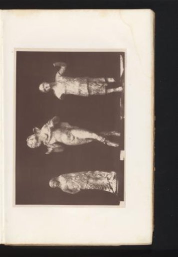 Three terracotta sculptures of a young woman in a double tunic, a young satyr, and a man