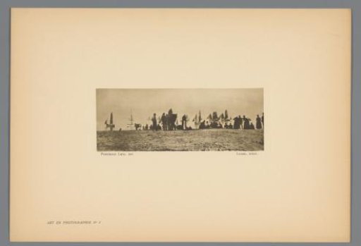 Group of people watching sailing ships at sea from the beach