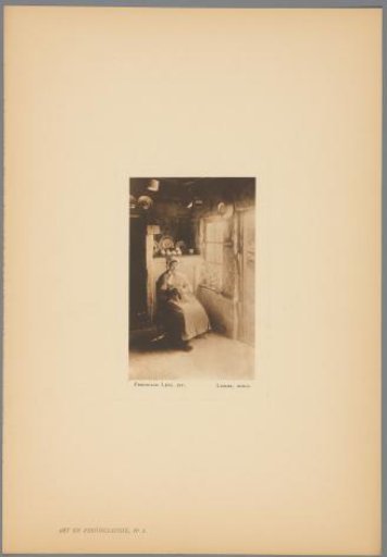 Woman seated with sewing in her hand