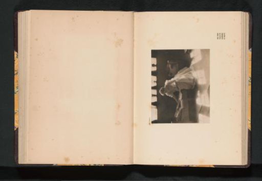 Seated Unknown Woman Viewing a Portfolio