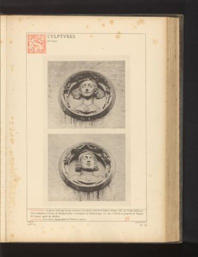 Two stone heads in the courtyard of Hof Bladelin in Bruges