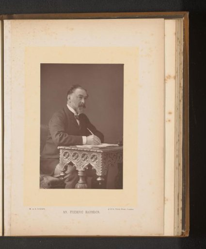 Portrait of Frederic Harrison behind a writing desk