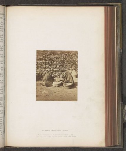 Two women grinding maize