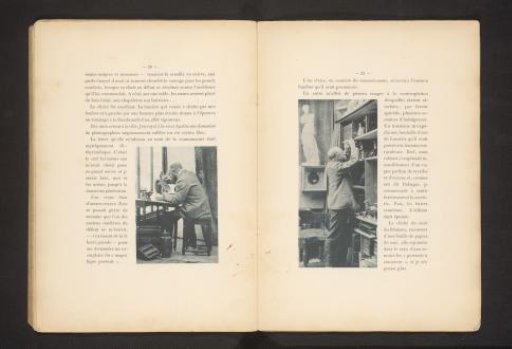 Man standing before a cabinet with boxes, in a room with a model of a classical sculpture and presumably a camera