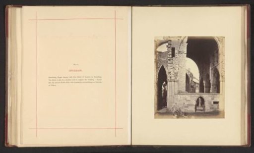 Interior of the ruins of Melrose Abbey with a man at a doorway