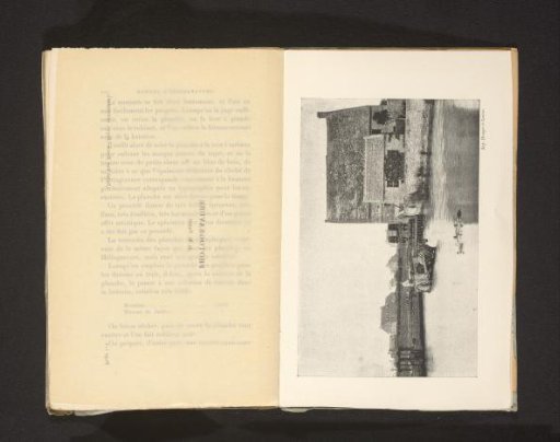 Man in a horse-drawn cart in the water before a house