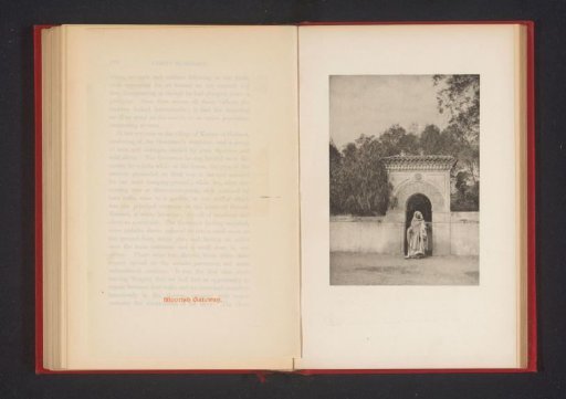 Old man in the opening of an entrance gate
