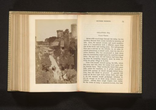 View of a fort on a hill next to a waterfall, probably in Italy