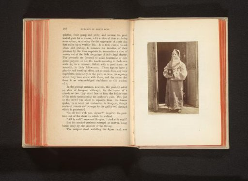 Figure in a monk's habit with a hood over the head in a doorway
