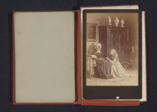 Portrait of an unknown girl kneeling beside an unknown old woman