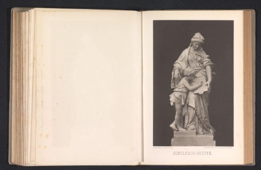 Sculpture, representing a woman teaching a child to write