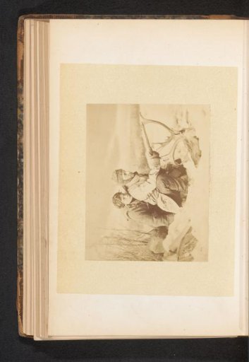 Two men with a pistol and an antler