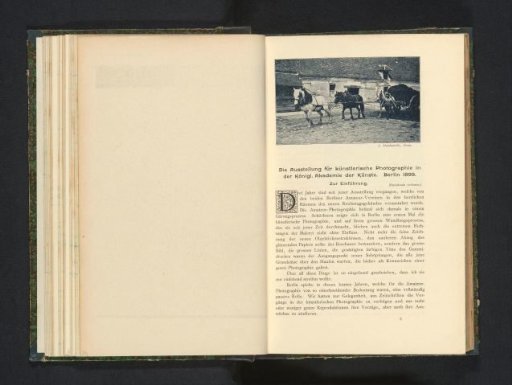 Man walking alongside three horses in front of a cart