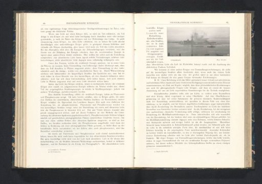 View of buildings by the water, with a steamboat in the foreground