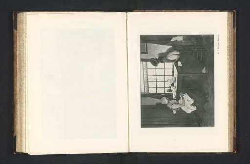 Two women sitting at a table doing needlework